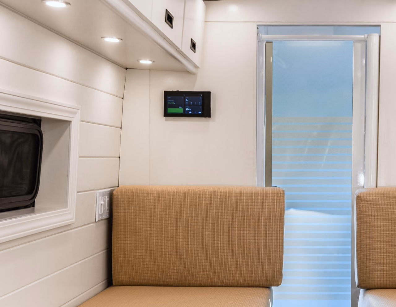 EcoFlow control panel mounted above the seating area inside a custom camper van.